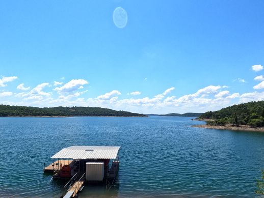 A serene lake view with trees on the banks.